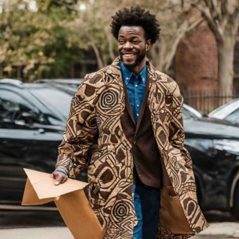 African man dressed in modern african print attire smiling