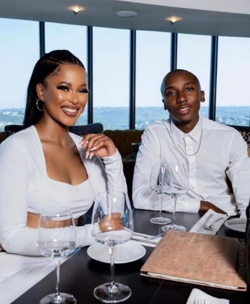 Internet sensation Ntando seated at an upper class restaurant with her boyfriend, both dressed in white